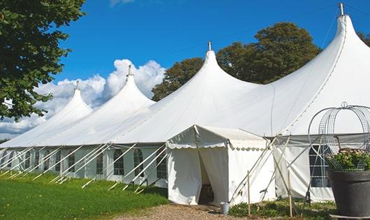 tall green portable restrooms assembled at a music festival, contributing to an organized and sanitary environment for guests in Oxford, CT